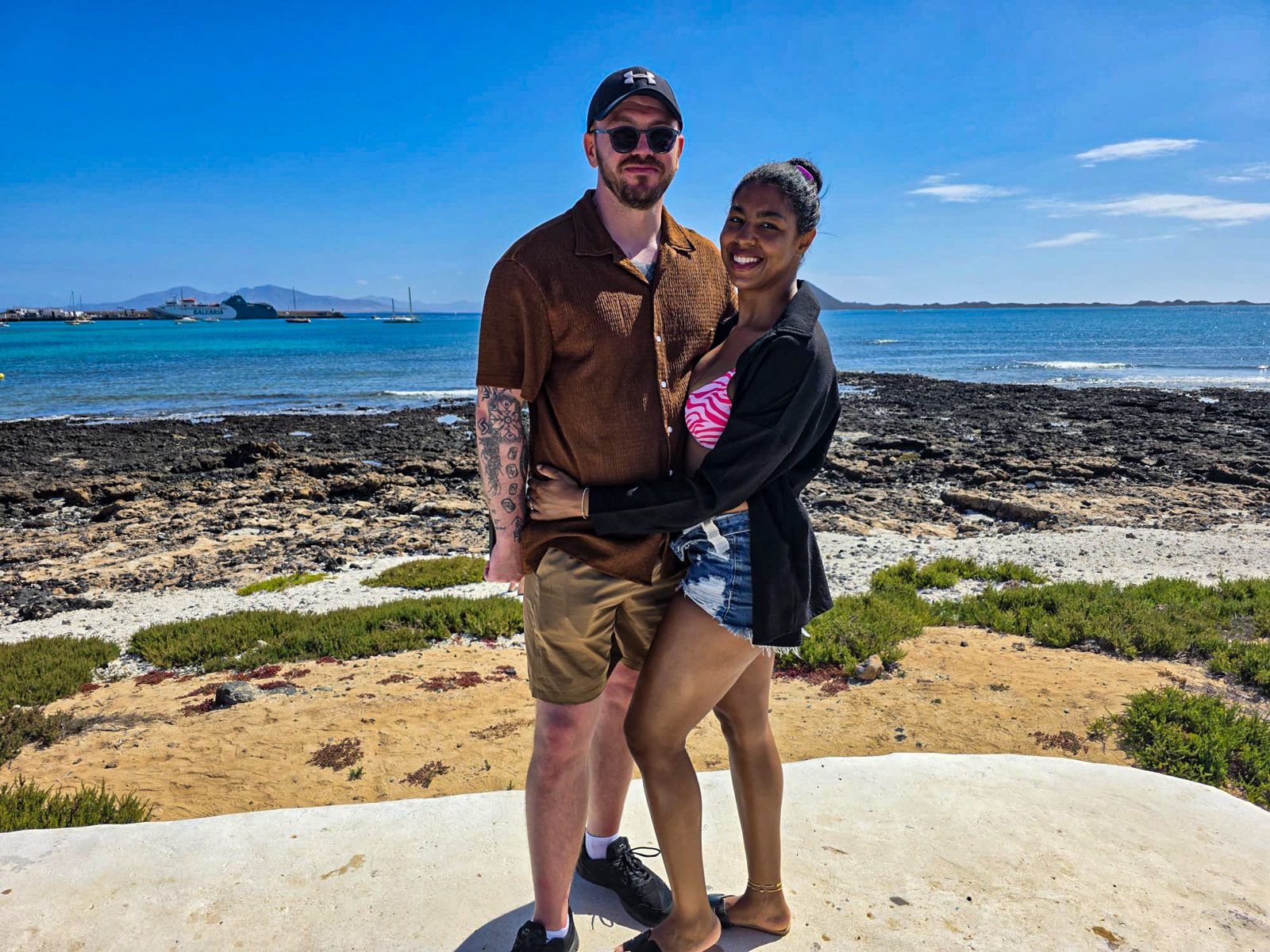 Couple embracing on a rocky shore